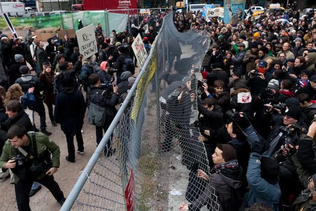 Protesters attempt to bend open the fence around Duarte Square
